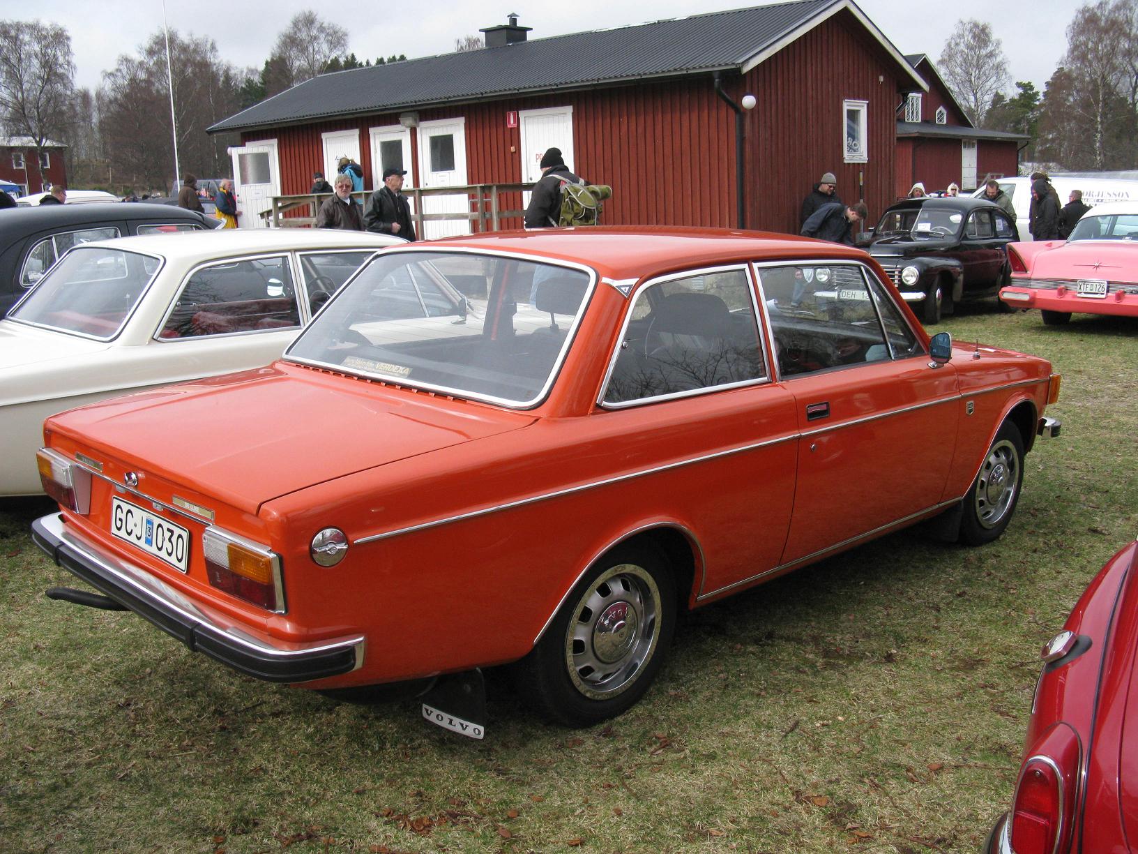 an old fashioned car is parked in the grass