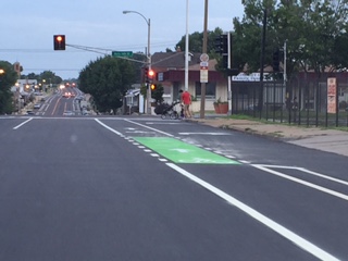 the stoplight is at an empty intersection in the street