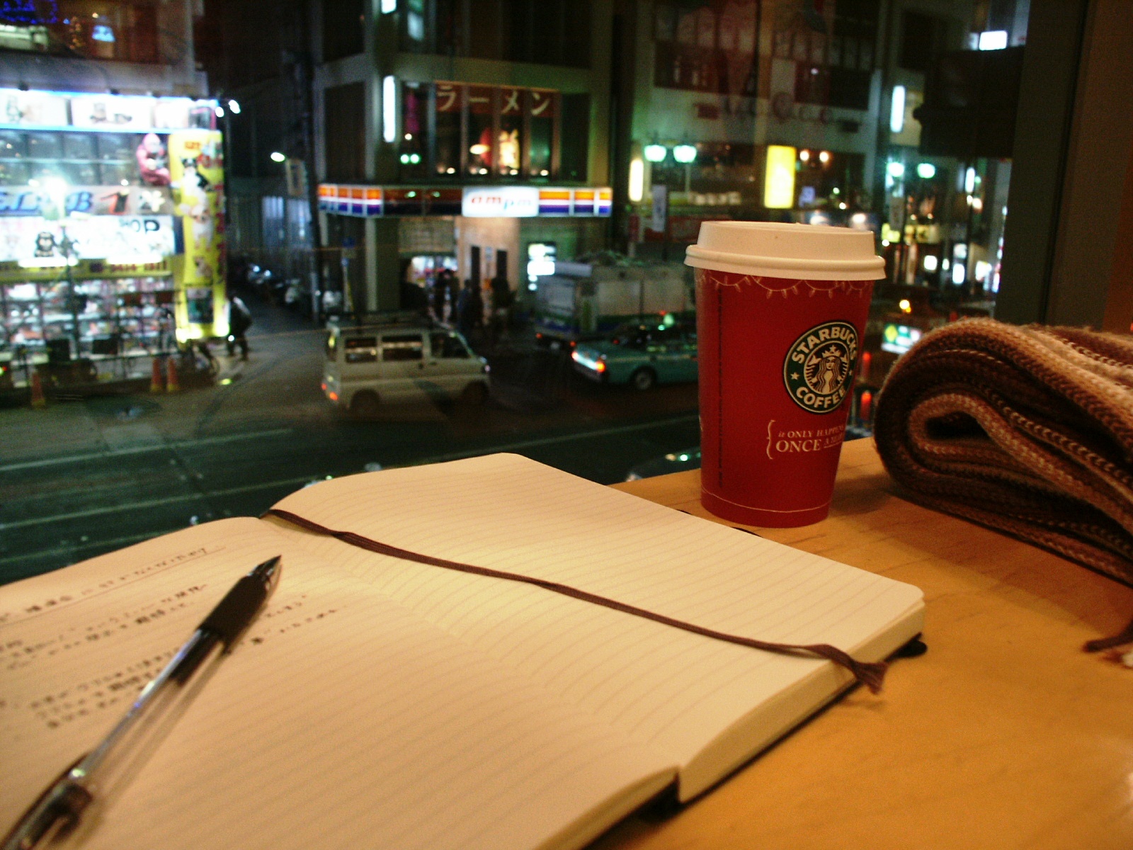 a cup of coffee and notebook on a table