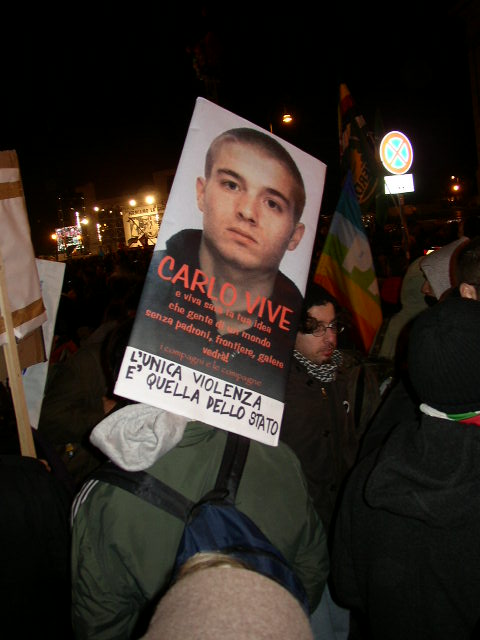 a protestor with a poster of emir vindictori