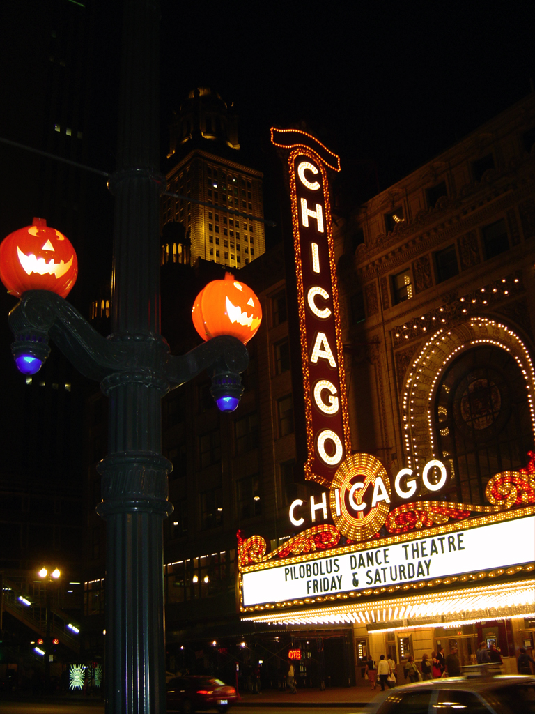 the chicago theatre in front of a city at night