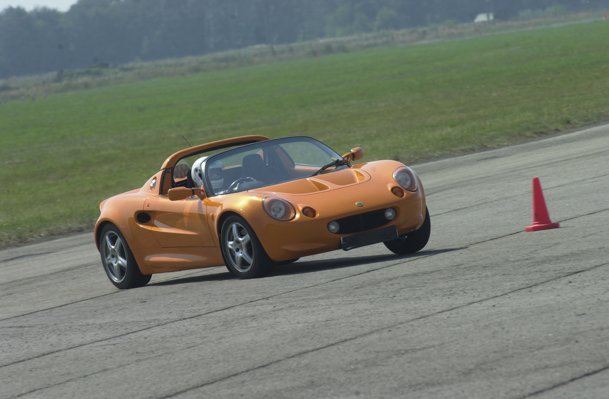 a convertible sports car making a turn around a corner