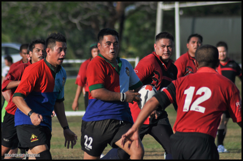 a soccer team running after the ball on the field