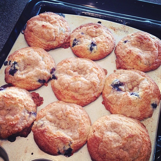 fresh baked blueberry cookies sitting on top of a baking sheet