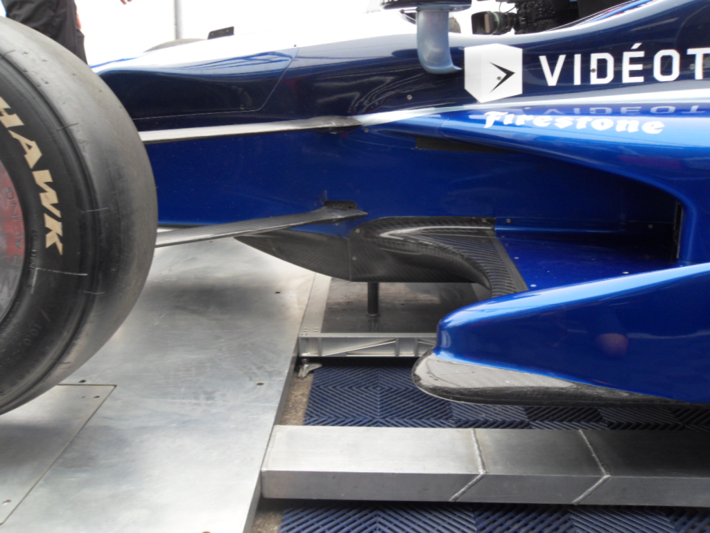 the front wheel of a blue race car