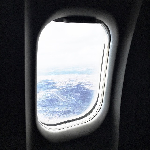an airplane wing looks out into the ocean