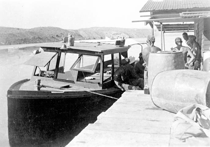 a boat is parked on the water near other boats