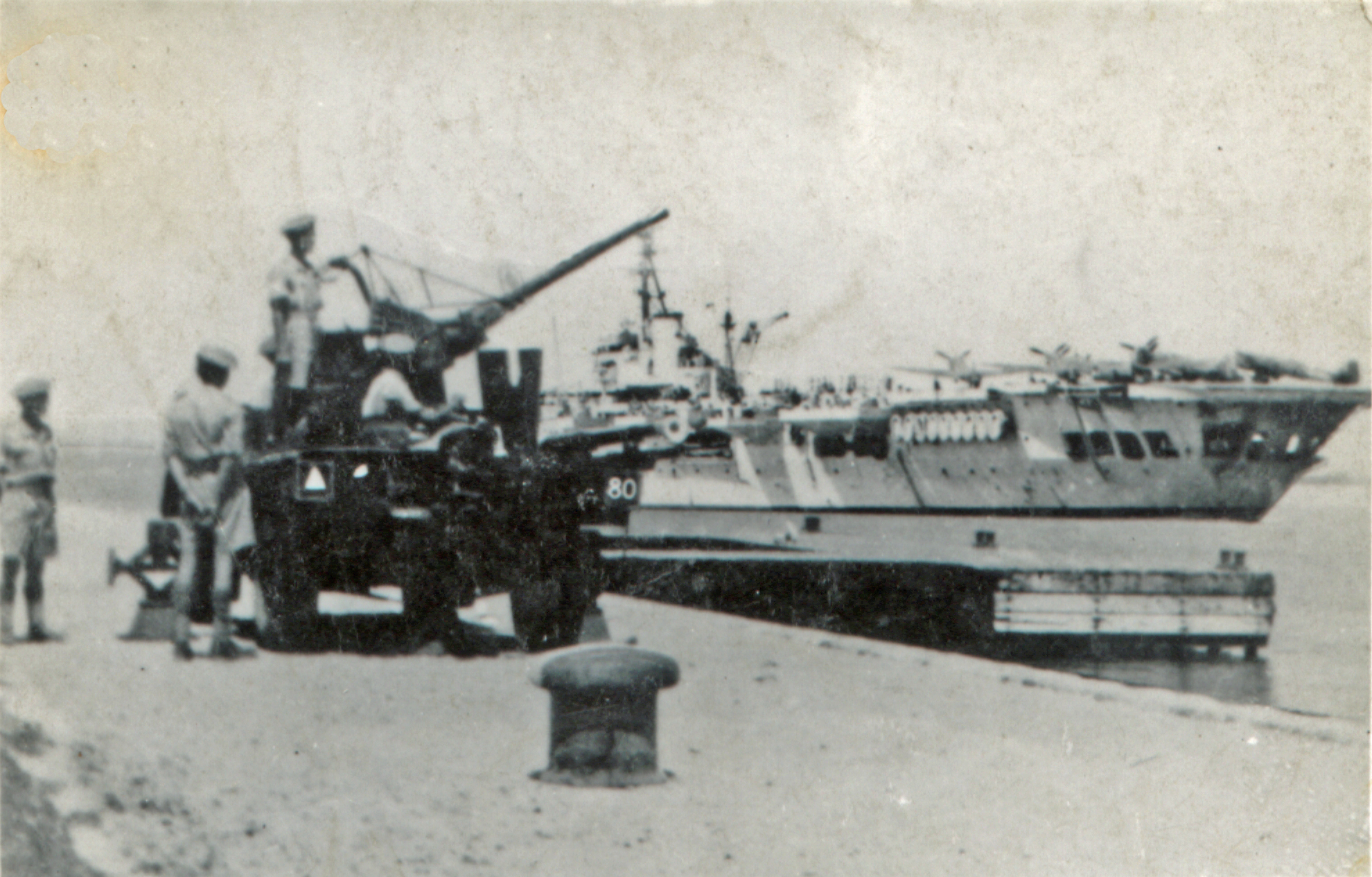 several men are standing near some docked boats