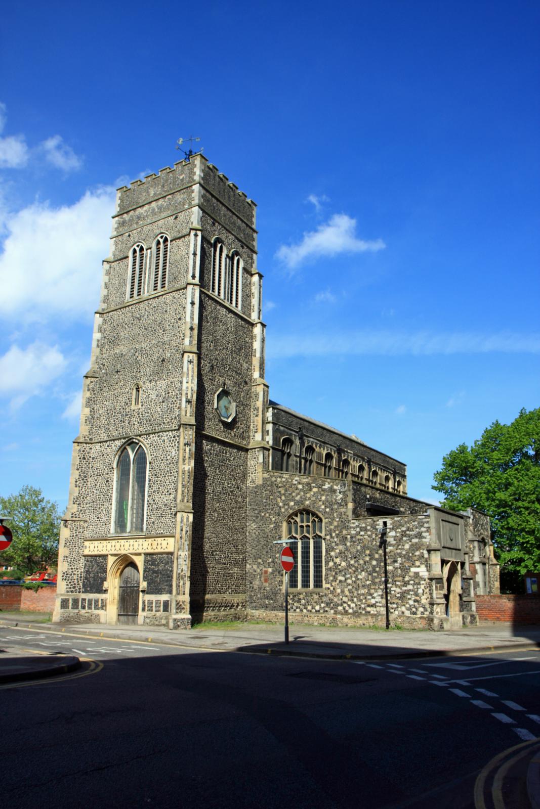 a large brick church standing next to a road