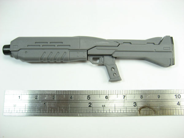 a close up of a gun and measuring ruler