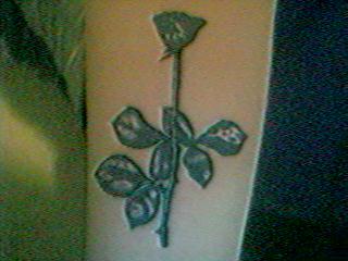 a picture of a tattoo with an interesting flower