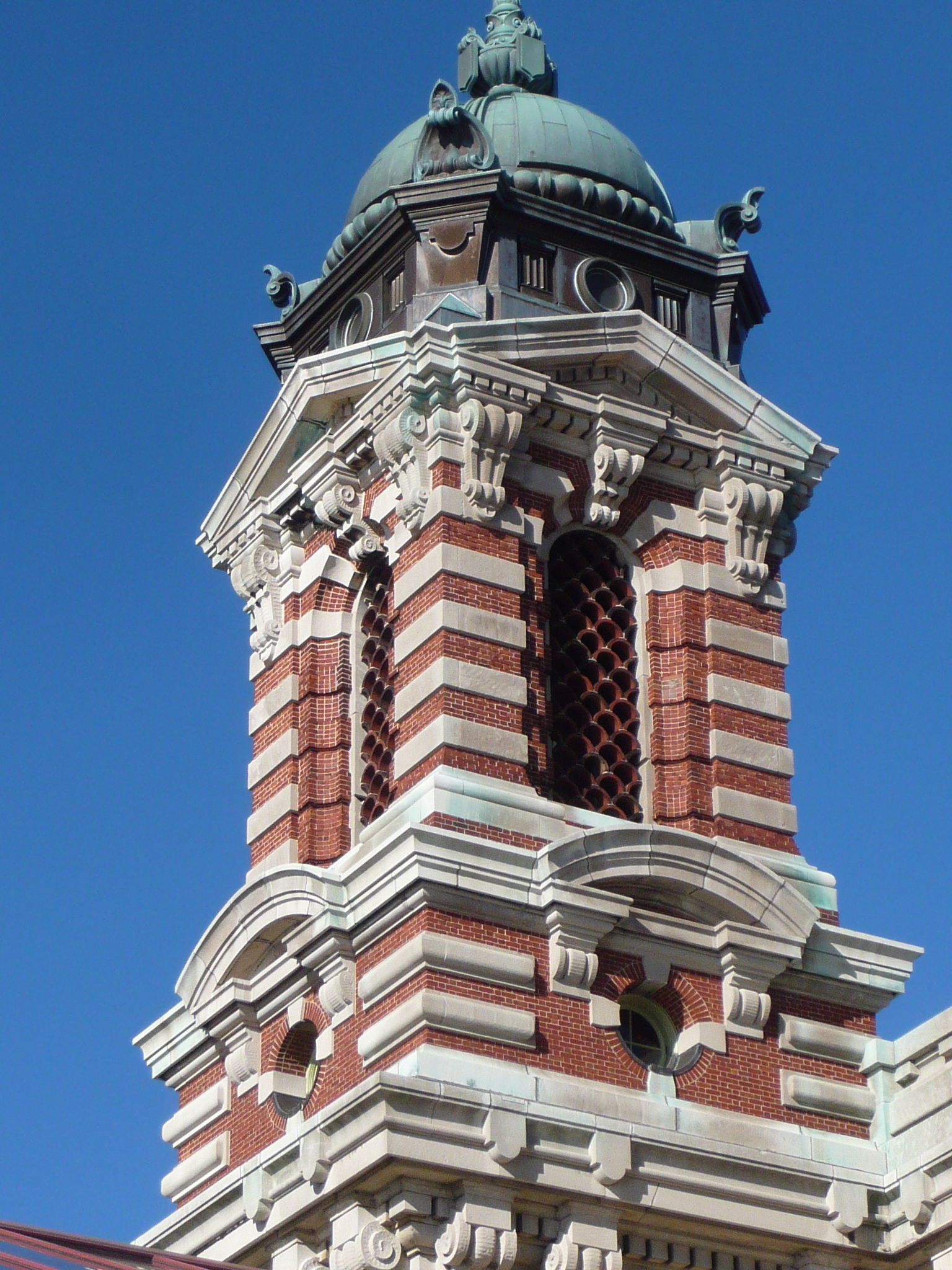 an old brick clock tower with a weather vein
