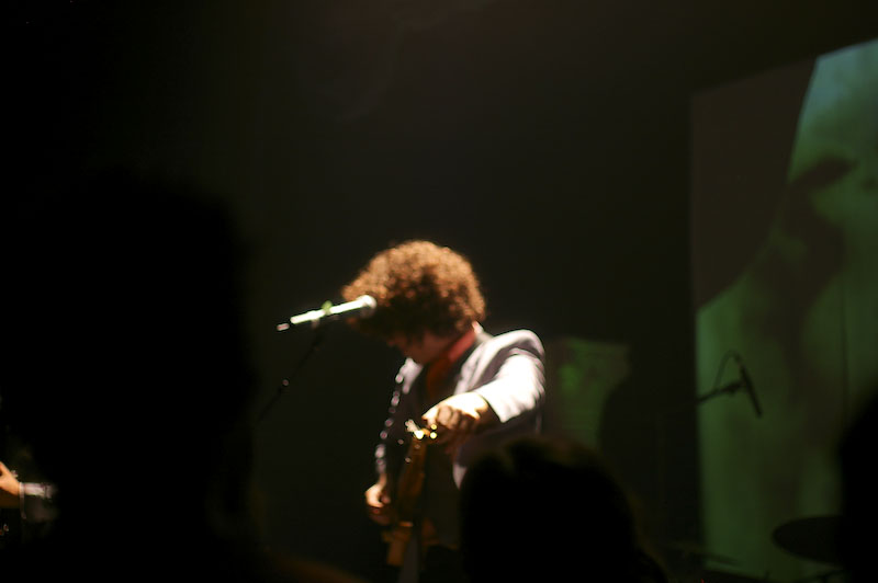 the guitarist is playing on his guitar at the concert