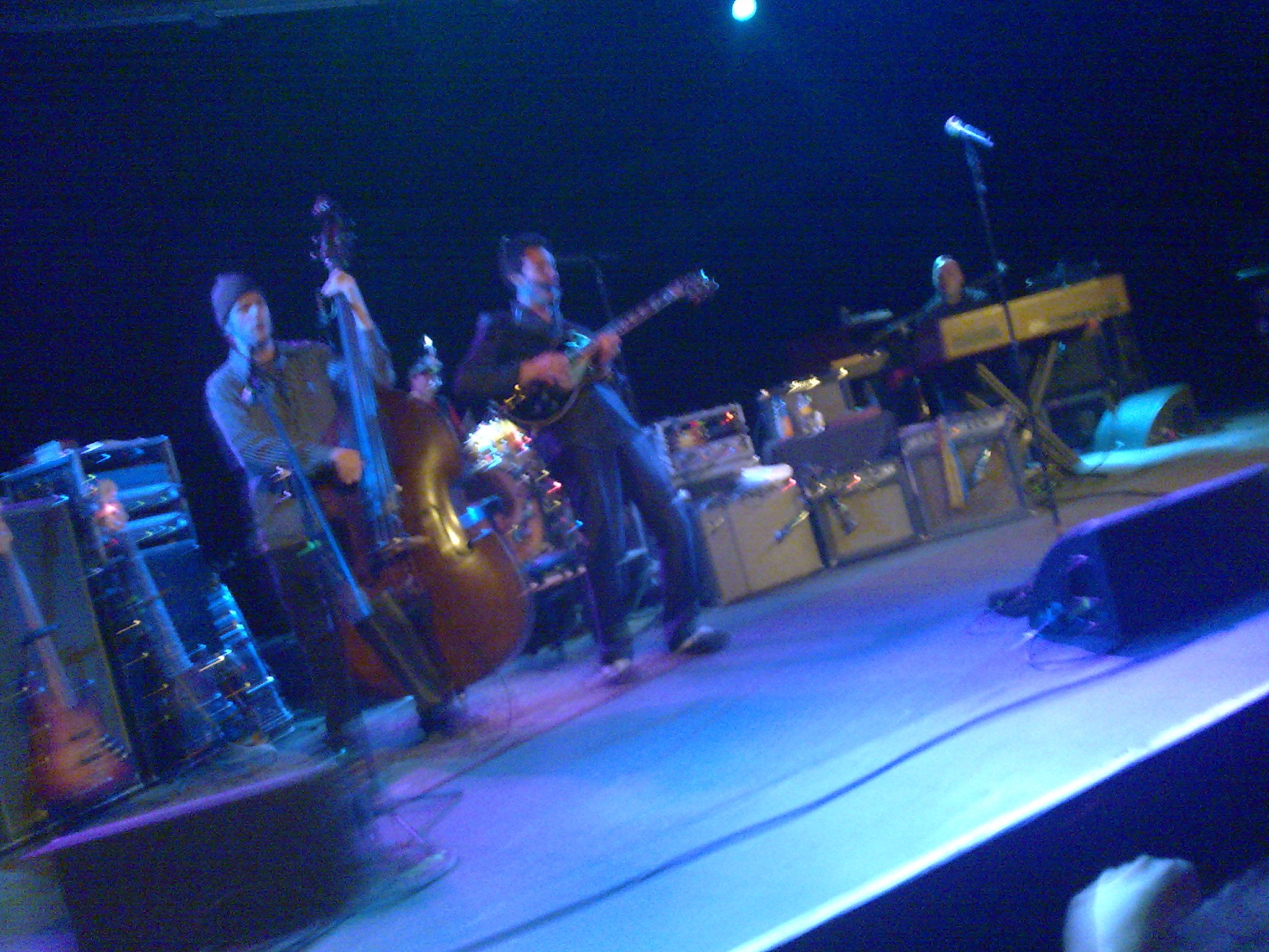 people on a stage singing and playing instruments