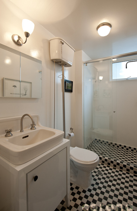 white fixtures and black and white tile in a bathroom