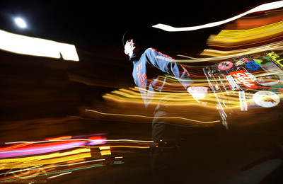 blurry image of a skateboarder going through a nighttime time