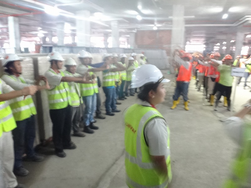 a group of people wearing yellow vests and hard hats