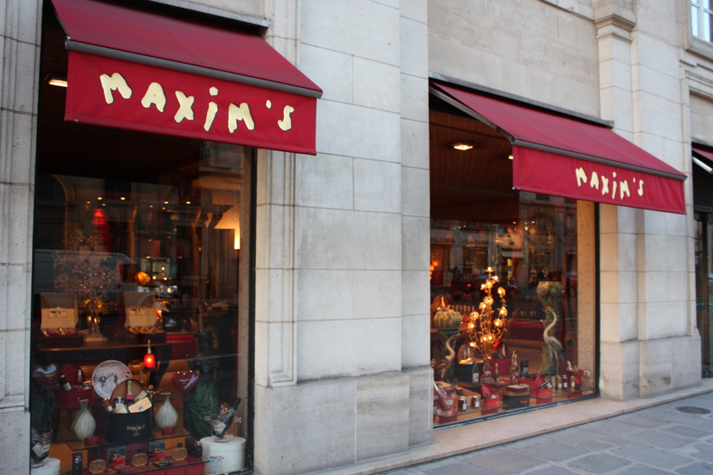 a store front has red awnings over the window