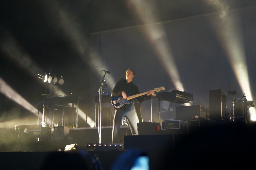 man playing an electric guitar with other music instruments on a stage