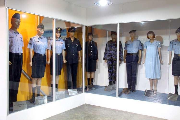 the uniforms are being displayed behind glass