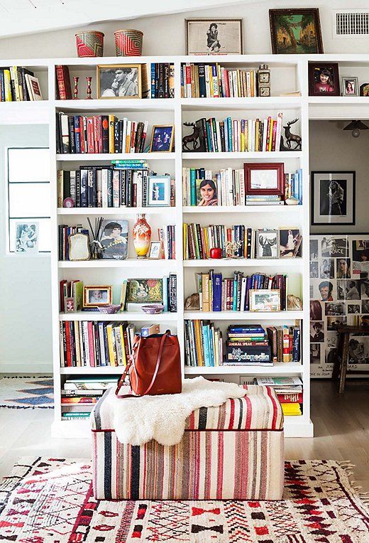 a book shelf filled with lots of books in a living room