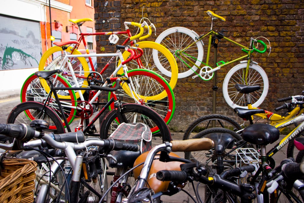 many bikes parked near each other in front of a building