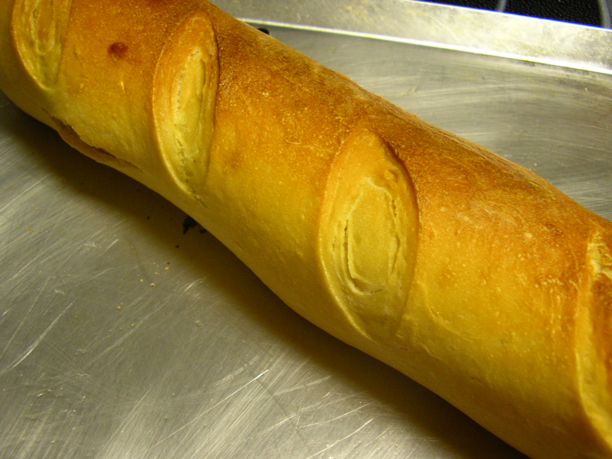 a big long piece of bread is on the counter