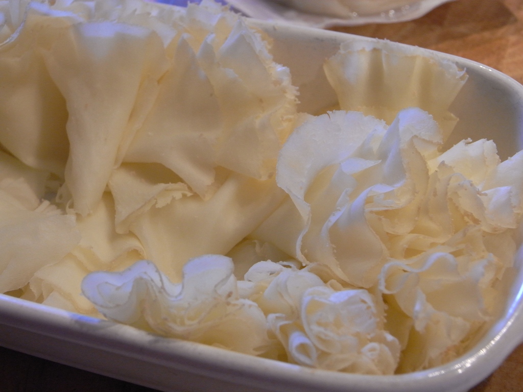 a container filled with white flowers on top of a table