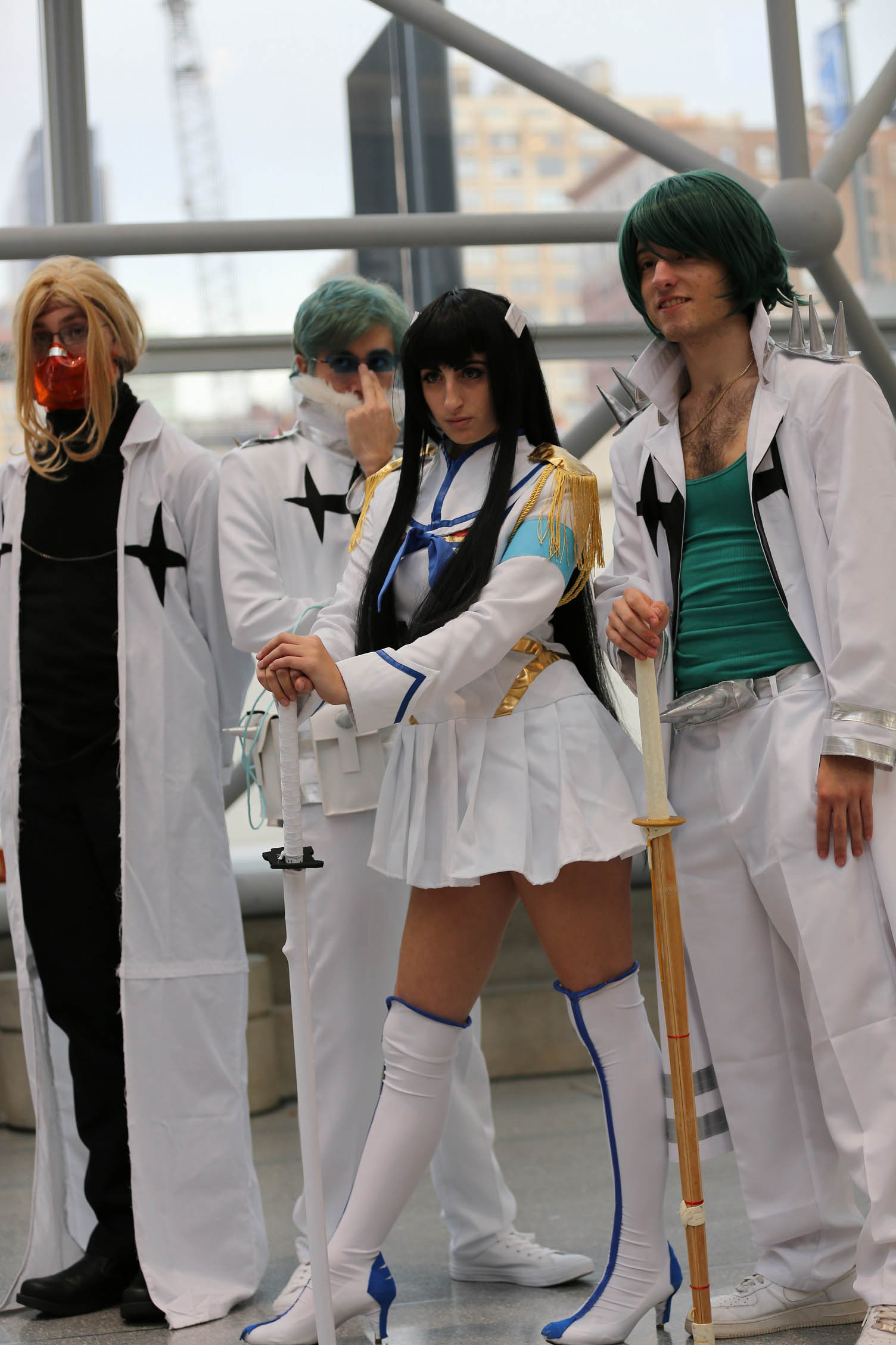 a group of people in costumes standing on the sidewalk