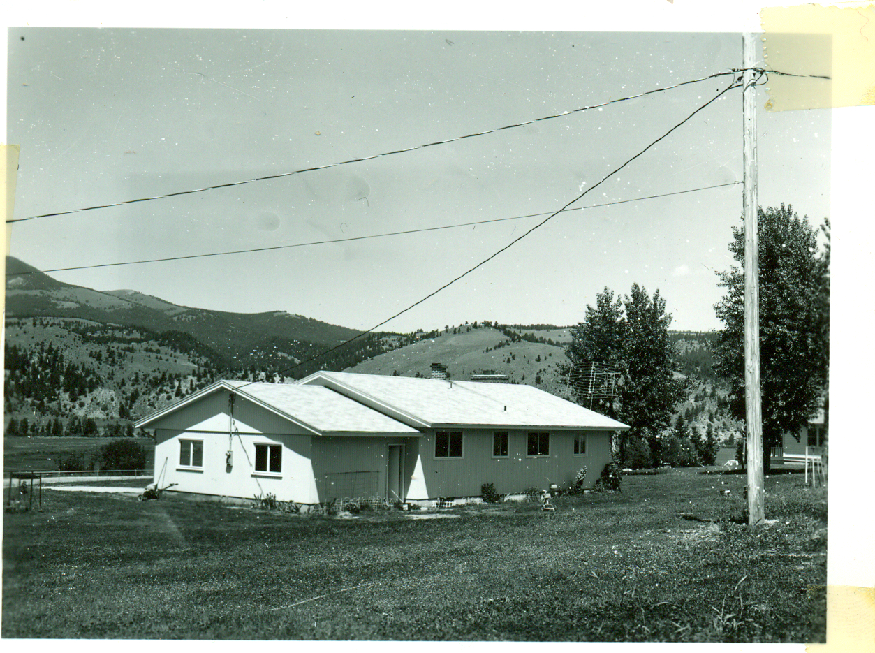 an old po of a white building and power lines