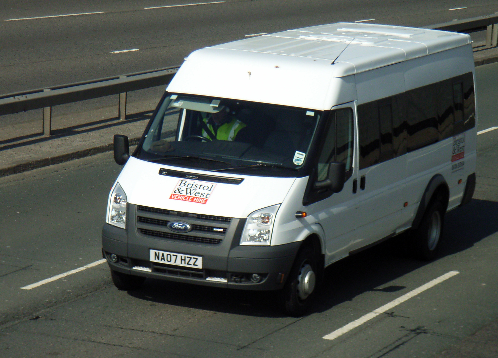 the van is traveling down the road in traffic