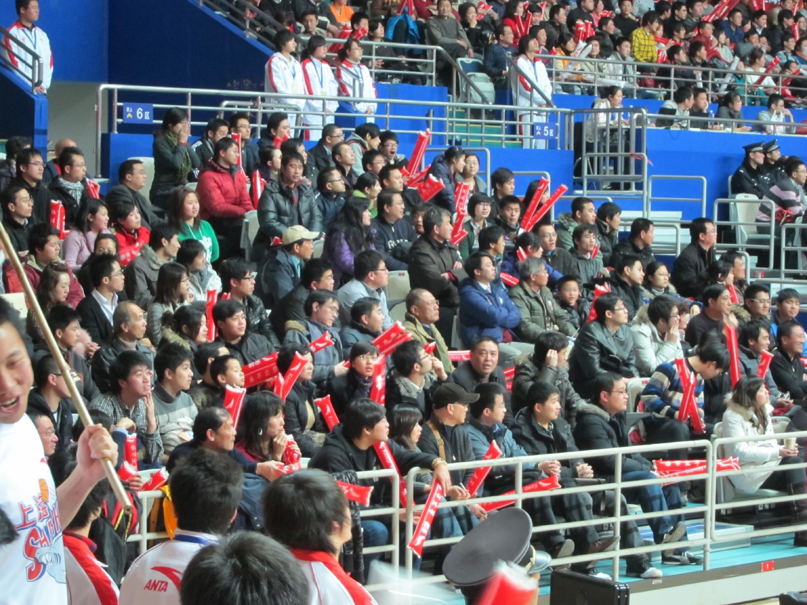 a stadium filled with people sitting down and standing