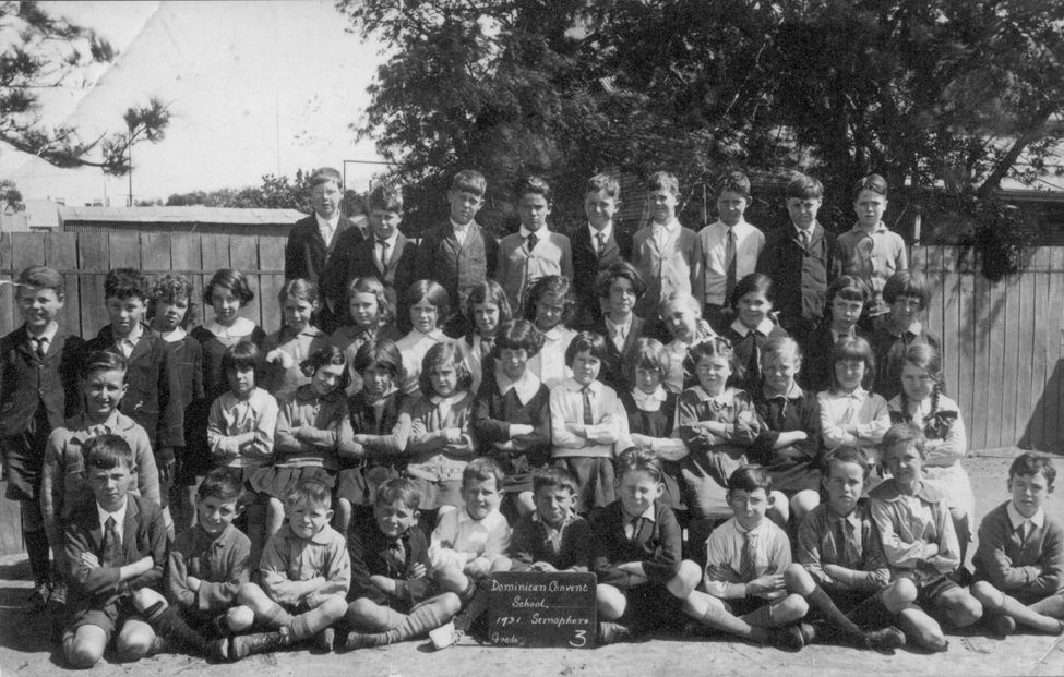 a school po with s, girls and parents posing for a group picture