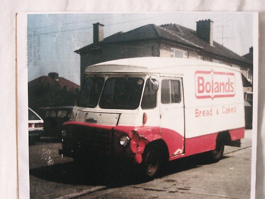 a red and white truck parked in front of a building