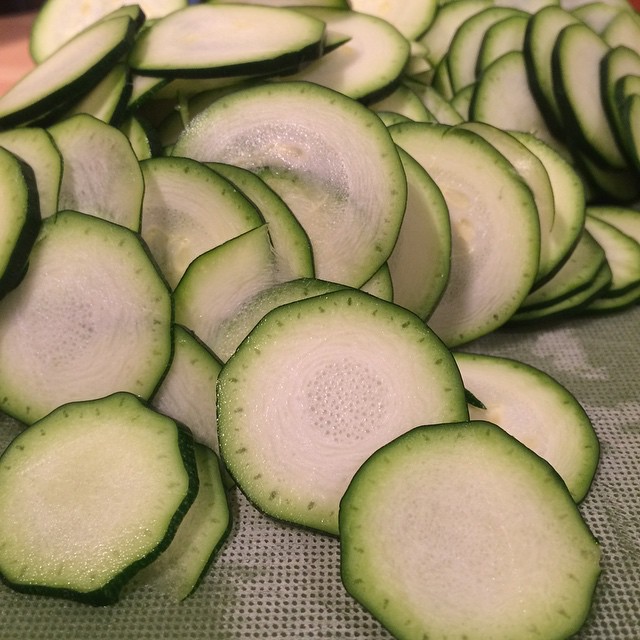 a close up of sliced cucumbers and a piece of bread