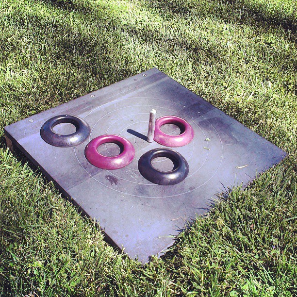 three pink handles sit on a metal object in the grass