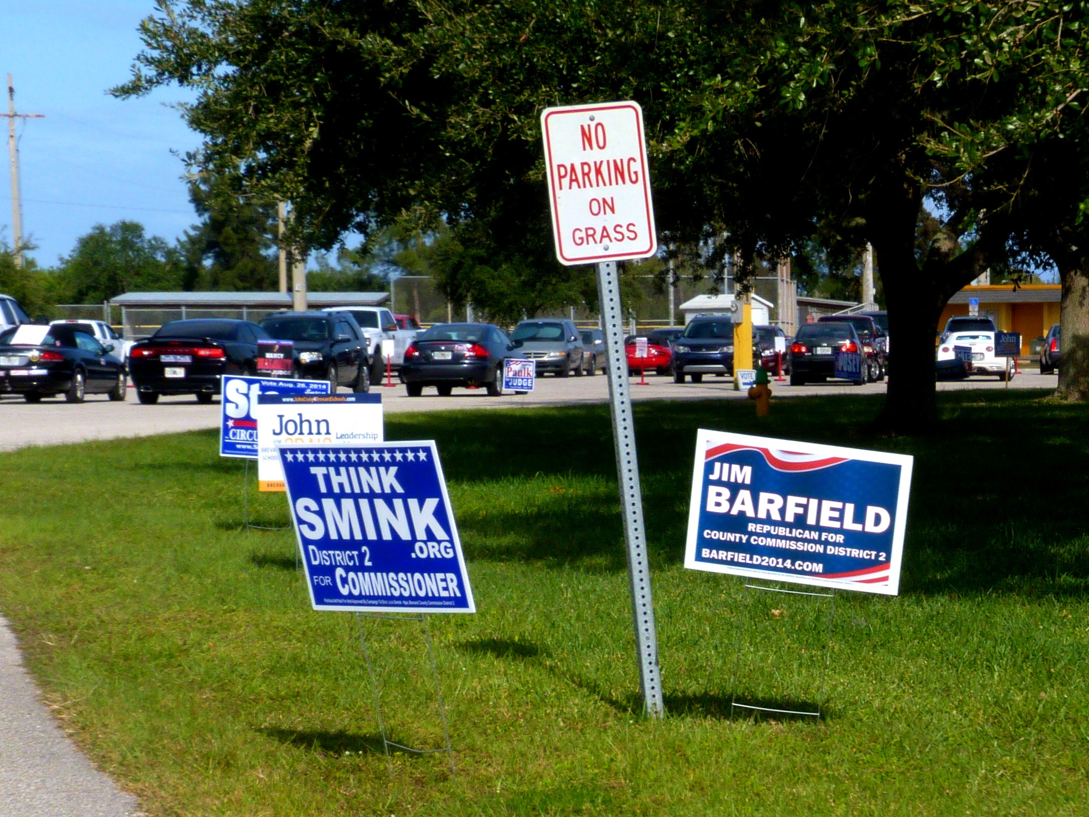 several signs at a parking lot advertising various tax options