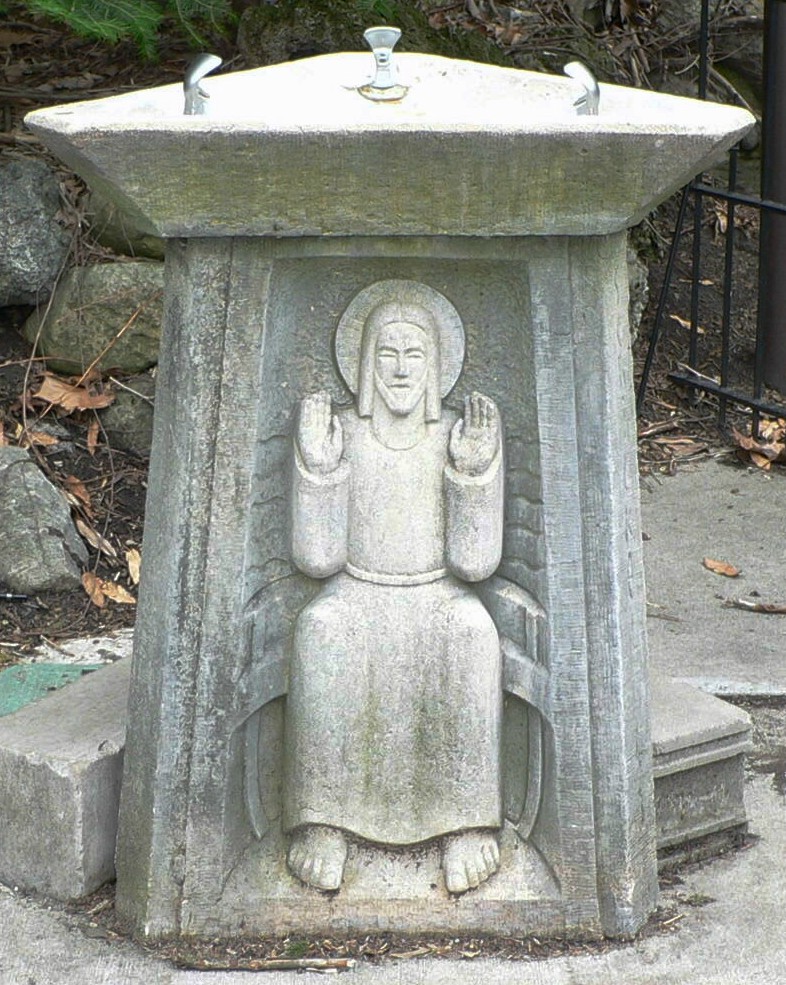 a cement statue with a person inside sitting on a stool