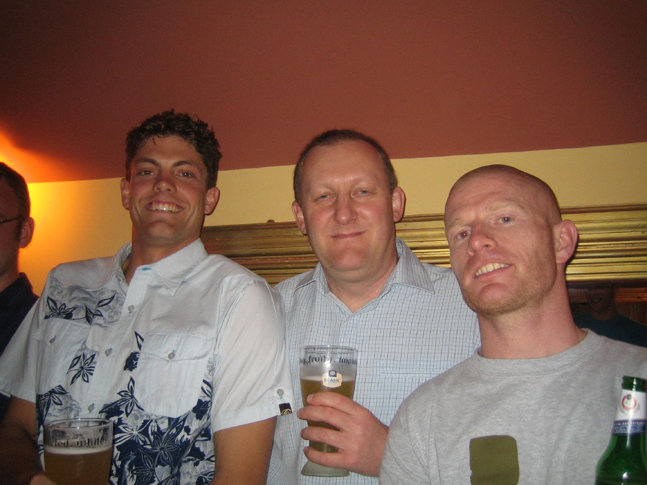 men in a group drinking at a party