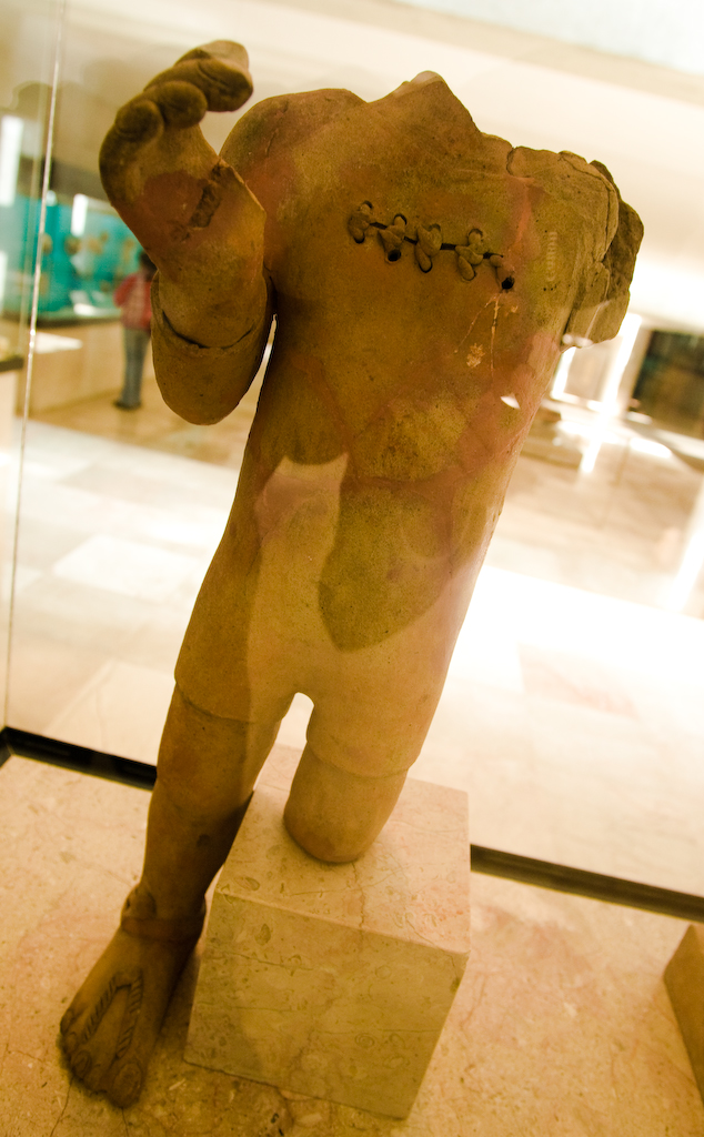 a brown sculpture of a person standing