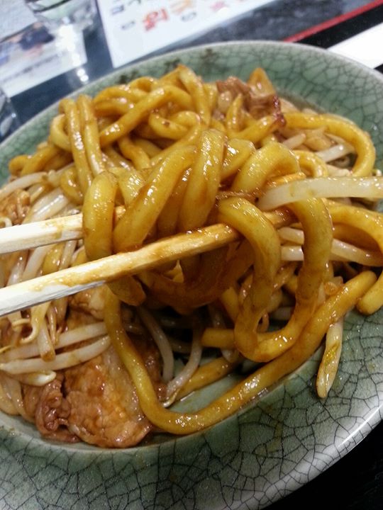 a green and white plate with noodles on it