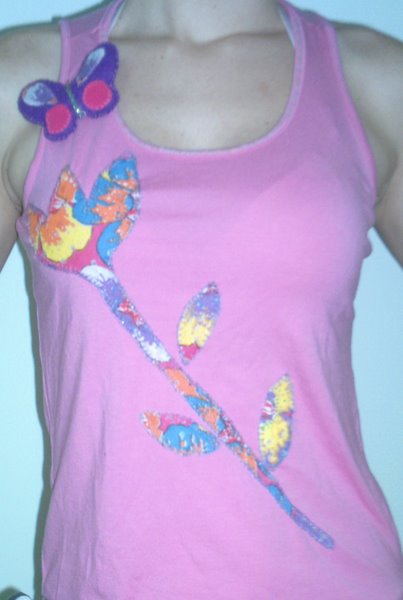 a woman's pink tank top with a flower