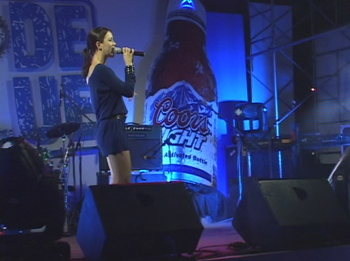 two girls on stage at a beer festival singing