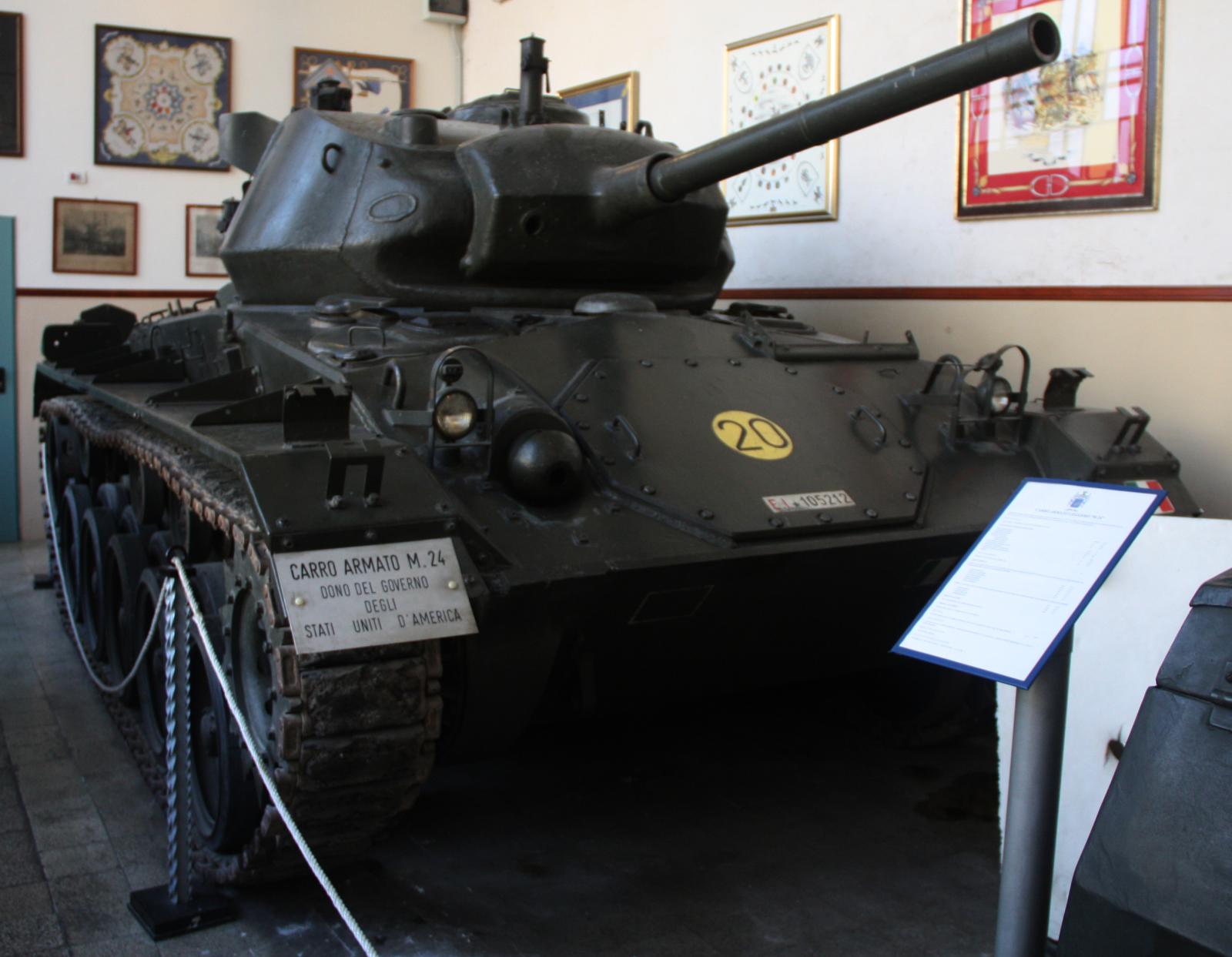 a museum looking at some old tanks in an exhibit