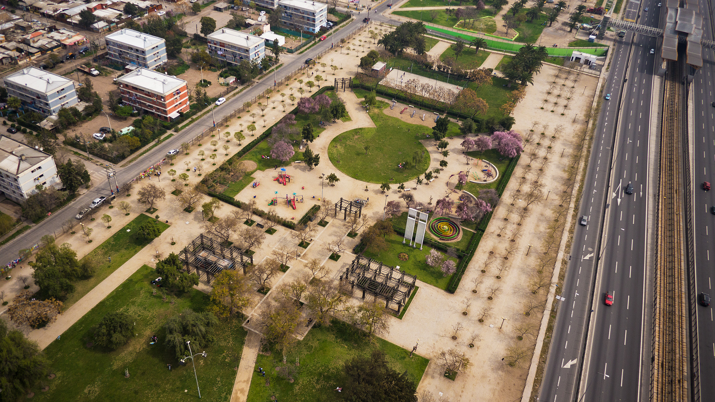 an aerial view of a rural city with a road and parking lot