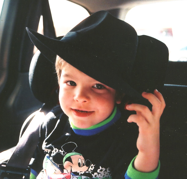 a  wearing a black hat with green trim