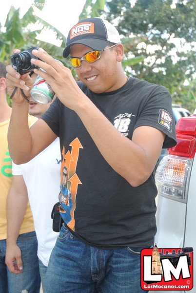 man in sunglasses holding up camera to take a picture