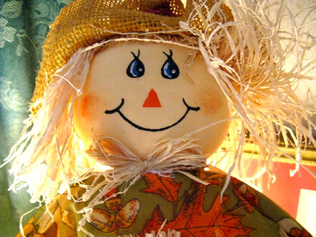 a wooden doll has a big hat and big eyes