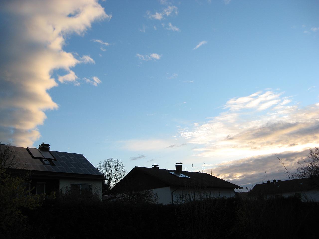 the house has a rooftop and is next to some houses