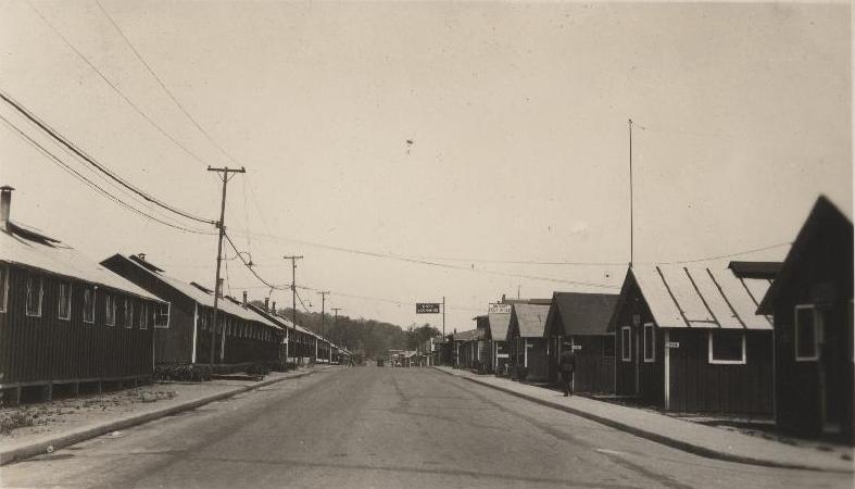 black and white pograph of street lined with buildings
